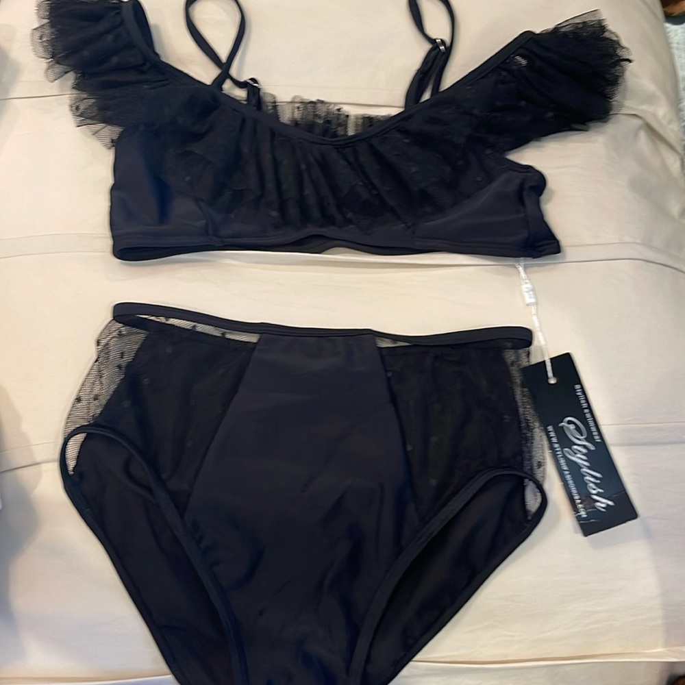 Black, high-rise medium size bathing suit with peekaboo and ruffle detail